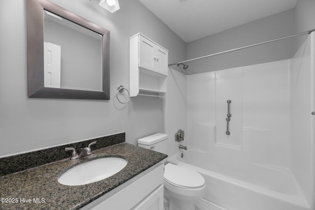 bathroom featuring toilet, a textured ceiling, shower / tub combination, and vanity