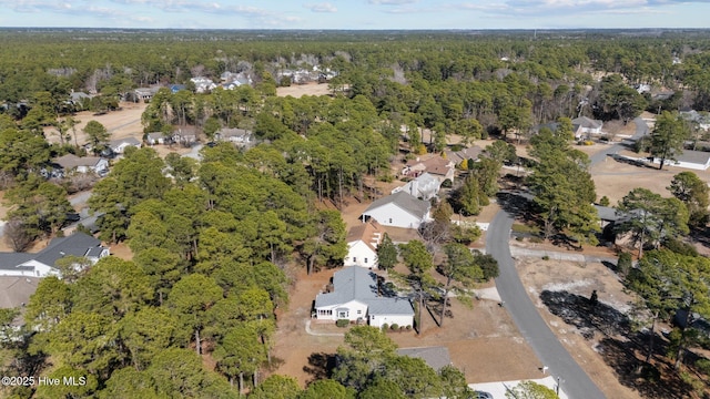 drone / aerial view with a residential view and a wooded view