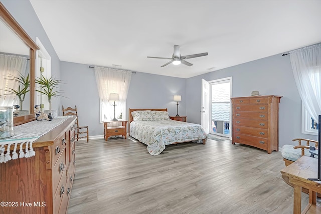 bedroom with light wood-style floors, ceiling fan, and baseboards