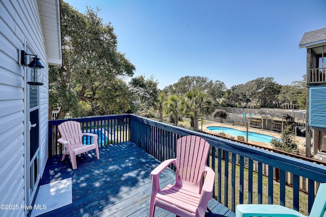 deck featuring a fenced in pool and fence