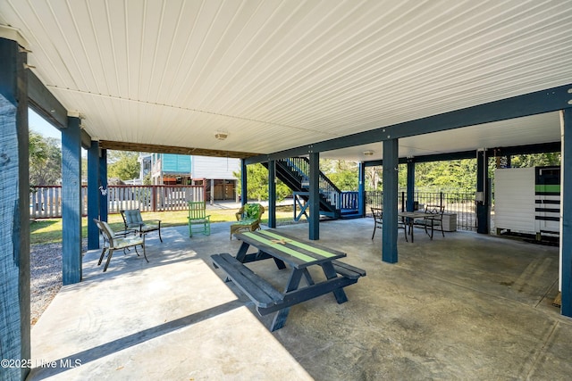 view of patio / terrace with stairway and fence