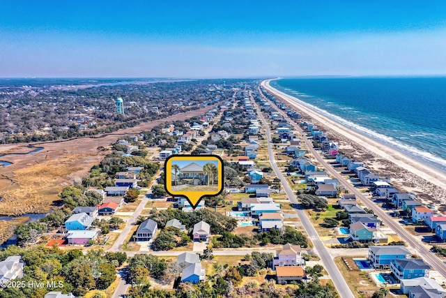 drone / aerial view featuring a water view and a view of the beach