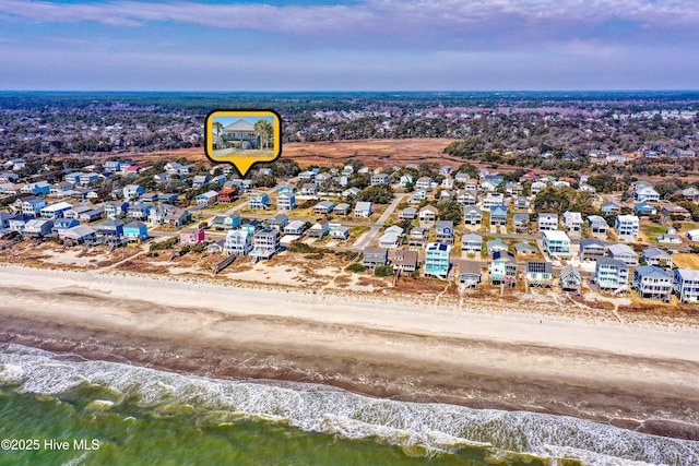 birds eye view of property featuring a residential view, a water view, and a beach view