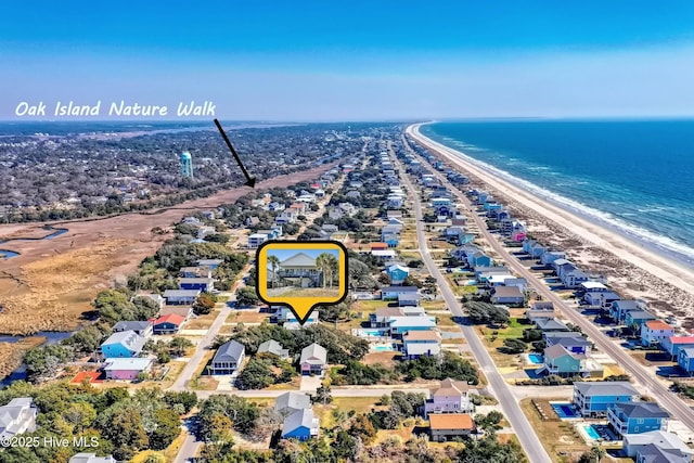 drone / aerial view with a beach view and a water view