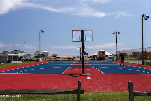 view of basketball court featuring community basketball court and fence