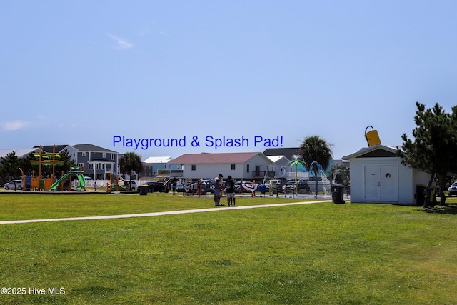 surrounding community with playground community, a residential view, a lawn, and an outdoor structure