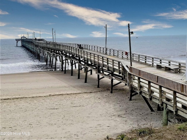 dock area featuring a pier and a water view