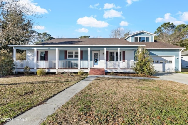 view of front of house featuring a front yard, a garage, and a porch