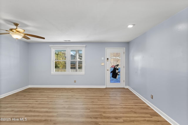 spare room featuring light wood-type flooring and ceiling fan