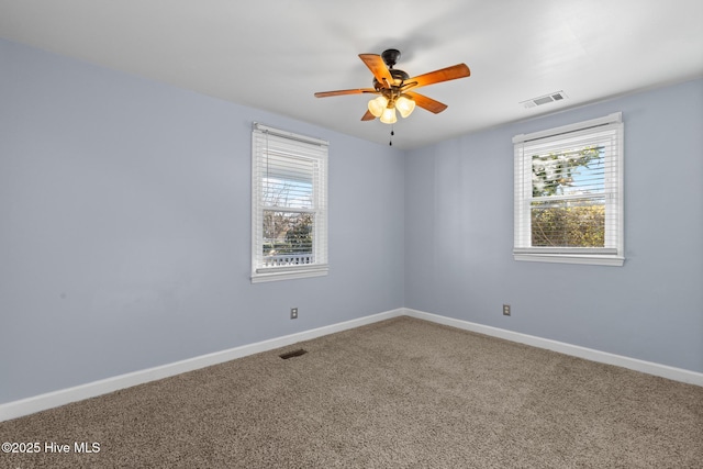 unfurnished room featuring ceiling fan and carpet floors