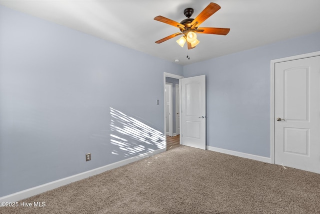 spare room featuring ceiling fan and carpet flooring