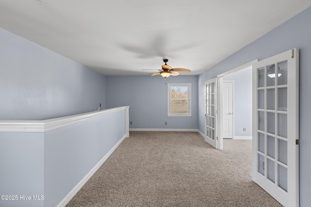 empty room with light carpet, french doors, and ceiling fan