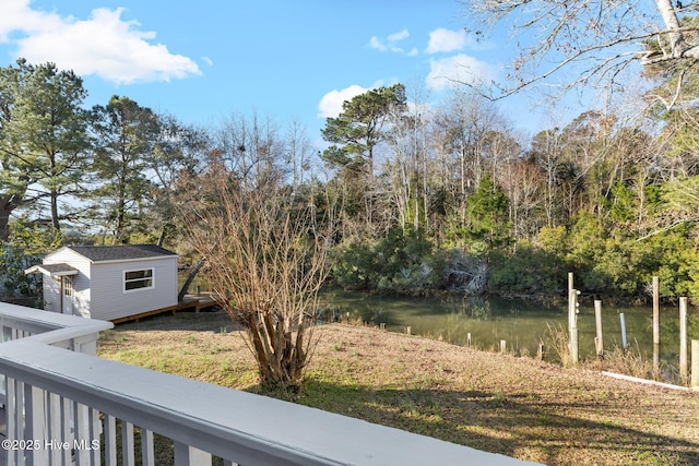 view of yard with an outbuilding and a water view