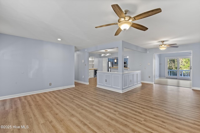 unfurnished living room featuring ceiling fan and light hardwood / wood-style floors