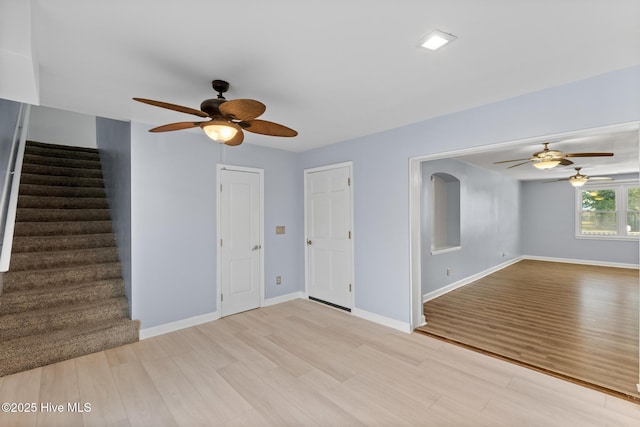 unfurnished living room with ceiling fan and light wood-type flooring