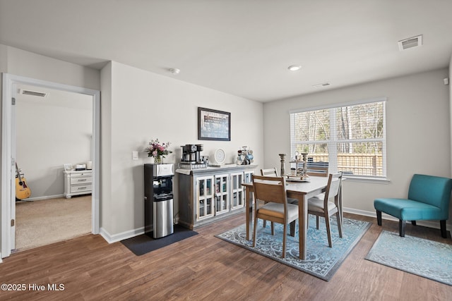 dining space with wood-type flooring