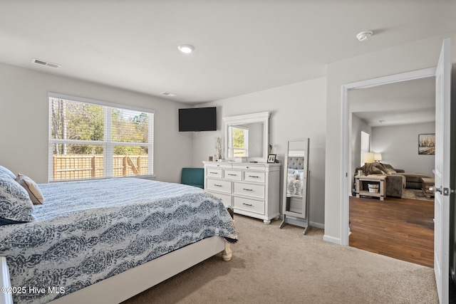 bedroom featuring light carpet