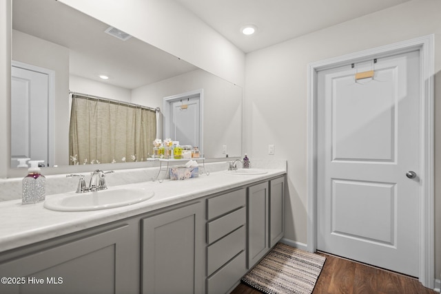 bathroom featuring hardwood / wood-style flooring and vanity