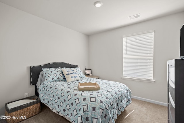 bedroom featuring multiple windows and carpet