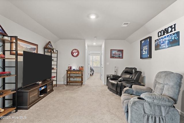 carpeted living room featuring vaulted ceiling