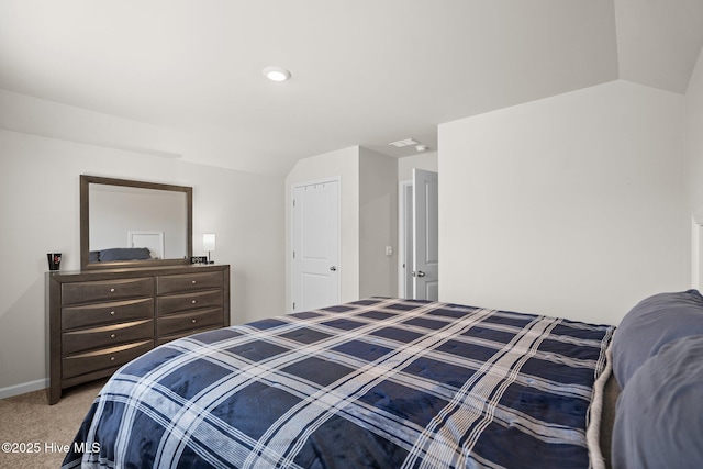 carpeted bedroom with vaulted ceiling