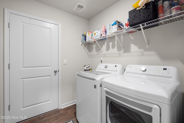 laundry area with separate washer and dryer and dark hardwood / wood-style floors