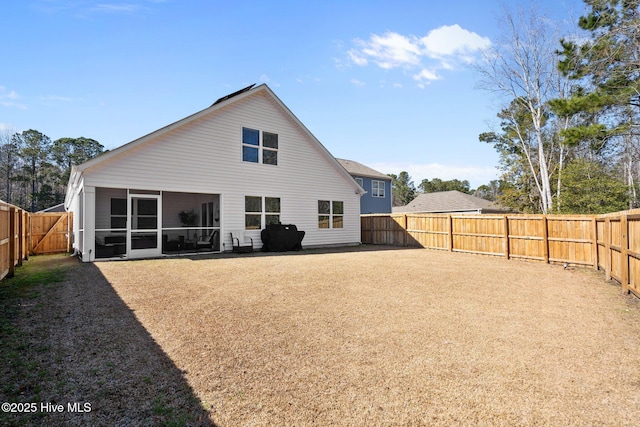 rear view of property with a sunroom