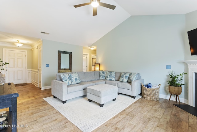 living room featuring ceiling fan, light hardwood / wood-style flooring, and high vaulted ceiling