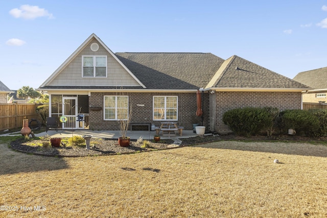 view of front of home with a front yard and a patio area