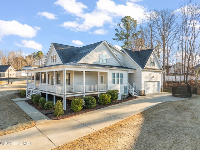 view of front of property with roof with shingles, a porch, concrete driveway, and an attached garage