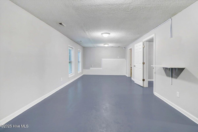 interior space with concrete floors and a textured ceiling