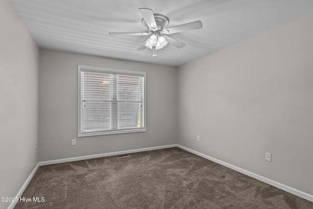 carpeted spare room with baseboards and a ceiling fan