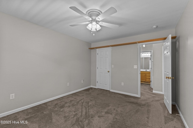 unfurnished bedroom with baseboards, a ceiling fan, carpet, and a sink