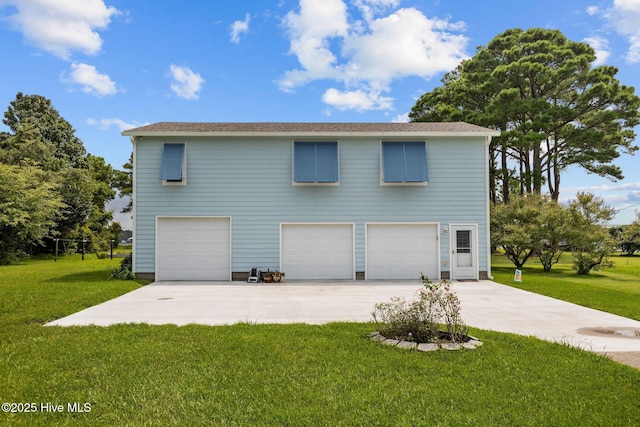 exterior space with an attached garage, driveway, and a lawn