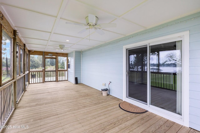 unfurnished sunroom with a ceiling fan and coffered ceiling