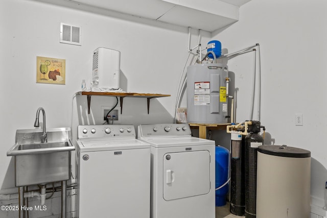 laundry room with washer and dryer, visible vents, a sink, water heater, and laundry area