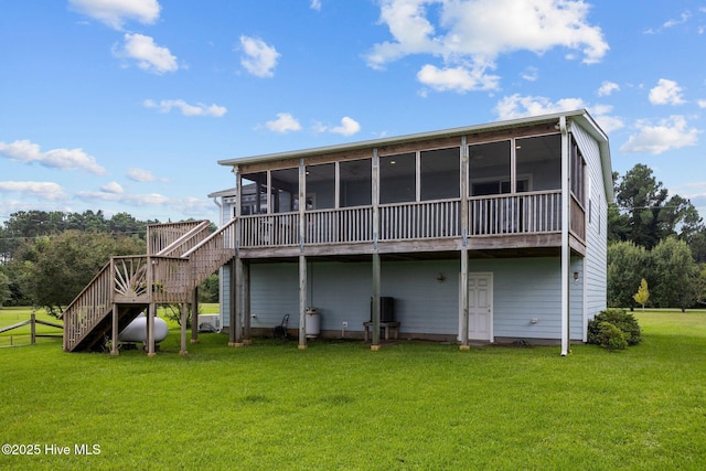 back of house with a sunroom, stairs, and a yard