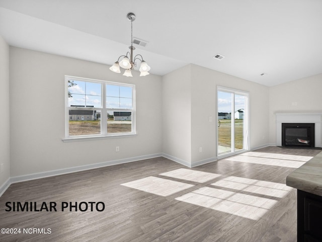 165 Vista Cay Dr, Hubert, NC 28539 - unfurnished living room with lofted ceiling, a chandelier, and light hardwood / wood-style floors