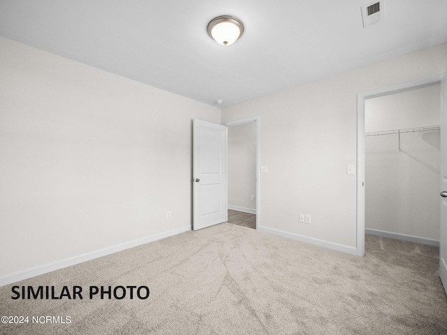 165 Vista Cay Dr, Hubert, NC 28539 - unfurnished bedroom with light colored carpet, a closet, and a walk in closet