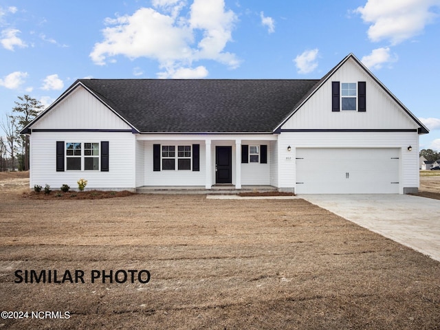 view of front of home featuring a garage and a front lawn