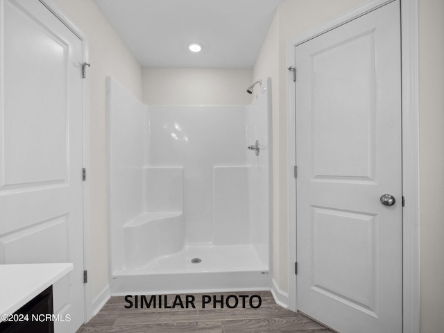 165 Vista Cay Dr, Hubert, NC 28539 - bathroom featuring vanity, hardwood / wood-style floors, and a shower