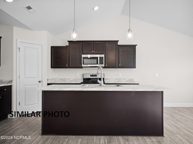 165 Vista Cay Dr, Hubert, NC 28539 - kitchen with pendant lighting, sink, dark brown cabinetry, and a center island with sink