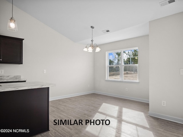 165 Vista Cay Dr, Hubert, NC 28539 - unfurnished dining area featuring light hardwood / wood-style floors and a chandelier