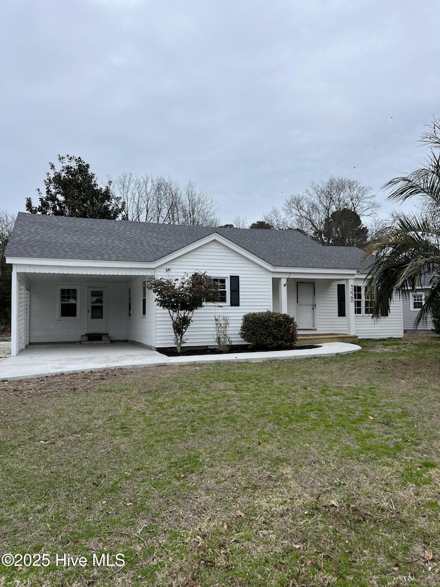 ranch-style house with a front yard and roof with shingles