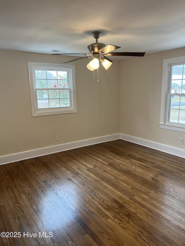 spare room with ceiling fan and dark hardwood / wood-style floors