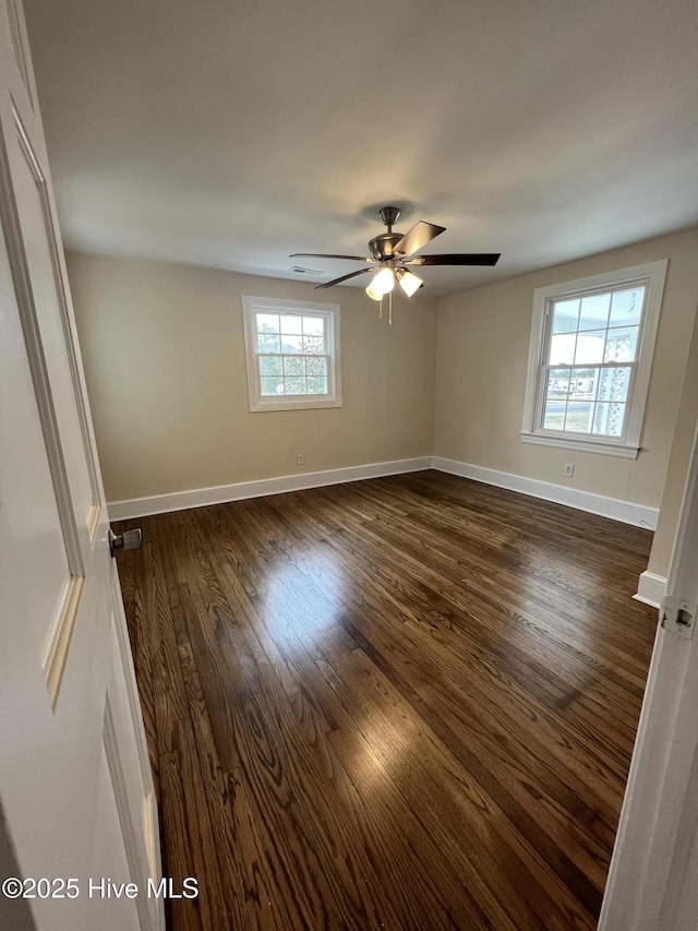 unfurnished room with dark hardwood / wood-style floors and ceiling fan