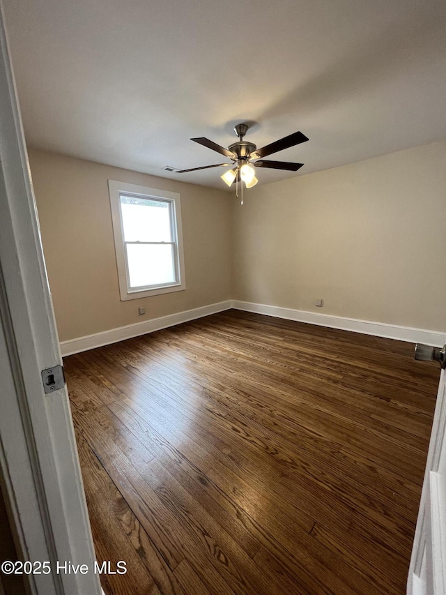 unfurnished room with dark hardwood / wood-style floors and ceiling fan