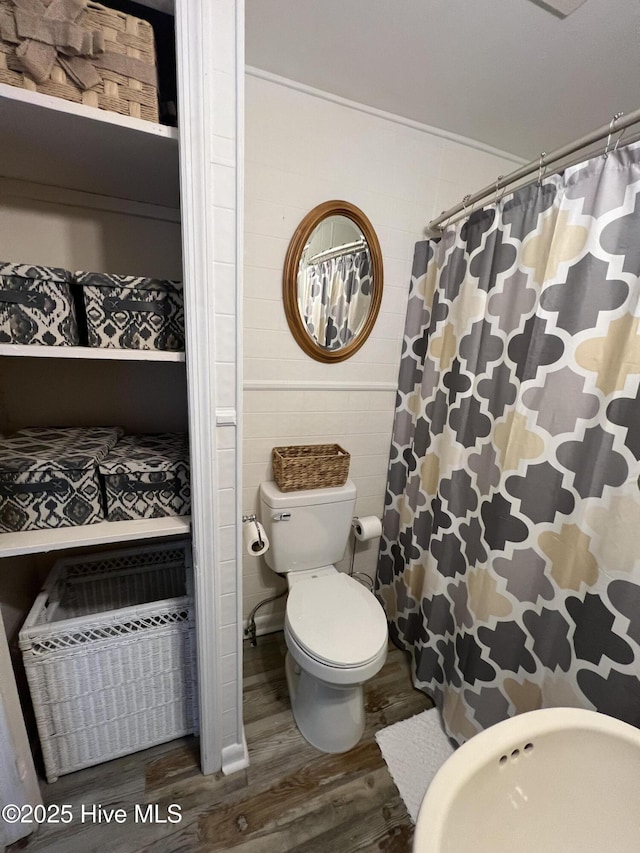 bathroom featuring hardwood / wood-style floors and toilet