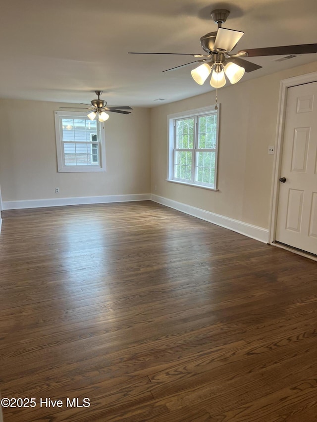 unfurnished room with dark wood-type flooring and ceiling fan