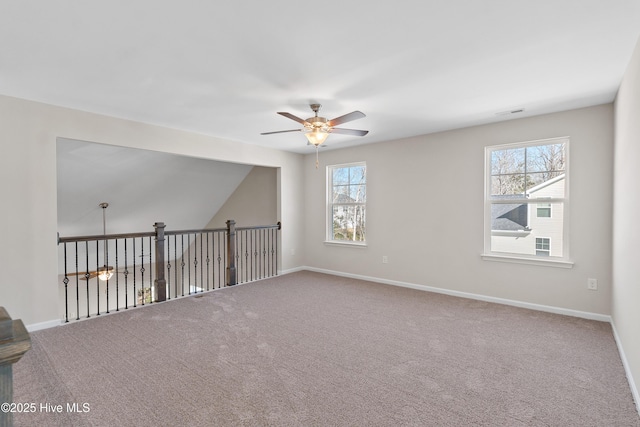 empty room featuring a ceiling fan, carpet floors, and baseboards